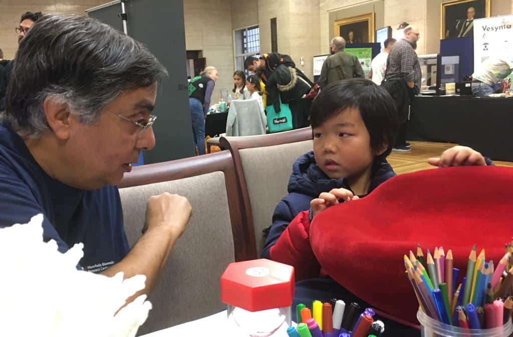 person speaking to child at an engagement event