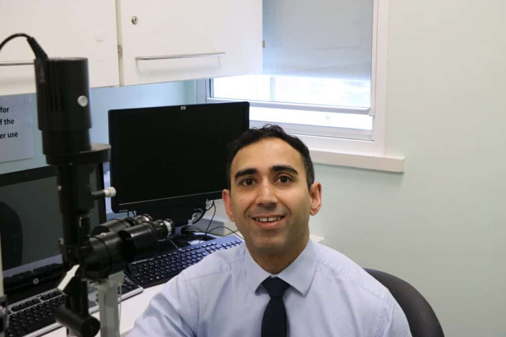 Image shows Professor Sajjad Ahmad sat at a desk