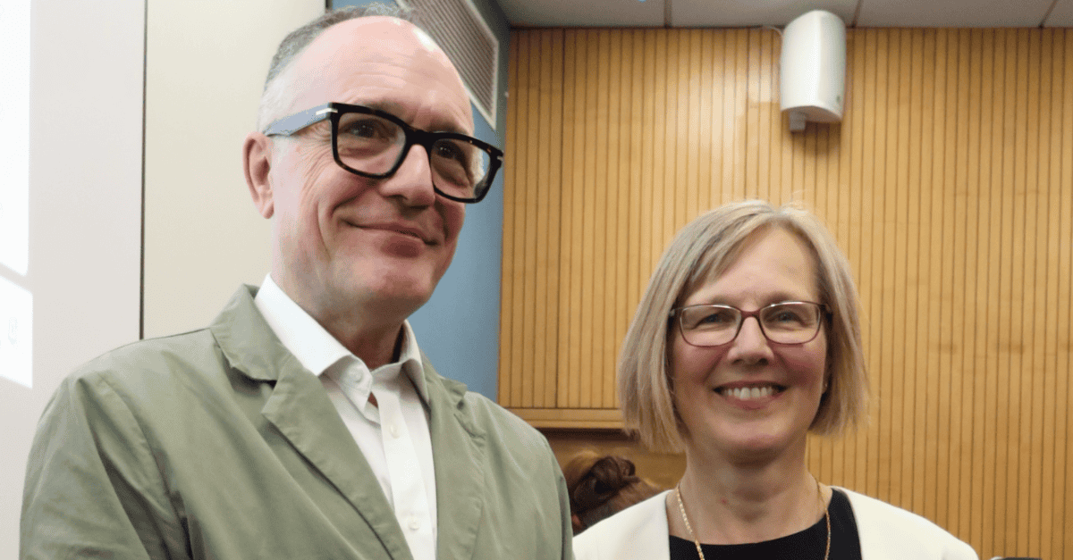 Two academics posing together at the conclusion of an inaugural lecture in a university lecture theatre.
